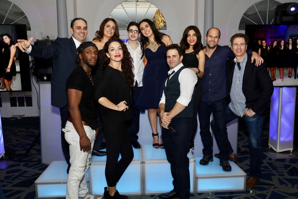 Jerry Laskin's crew posing with the family on a lit LED stage